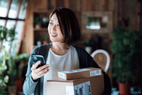 woman with packages purchased via online shopping