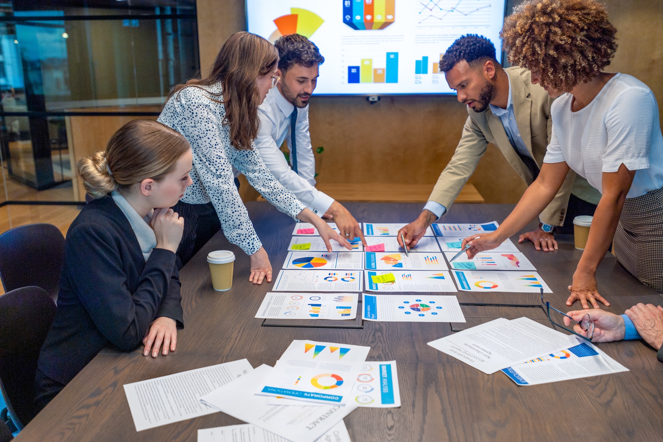 a group of marketing professionals reviewing data while developing a data-driven marketing strategy
