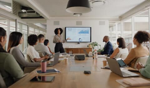 CMO leading a marketing meeting with an executive team